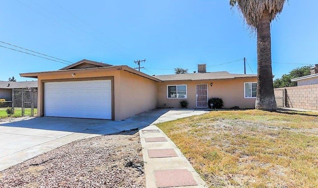 1083 Lorraine Pl, Rialto, CA 92376 - ranch-style house with stucco siding, an attached garage, and concrete driveway