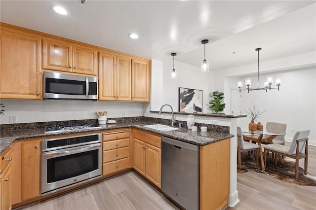 1800 Alma Ave Unit 106, Walnut Creek, CA 94596 - kitchen with appliances with stainless steel finishes, a peninsula, light wood-style flooring, a chandelier, and recessed lighting