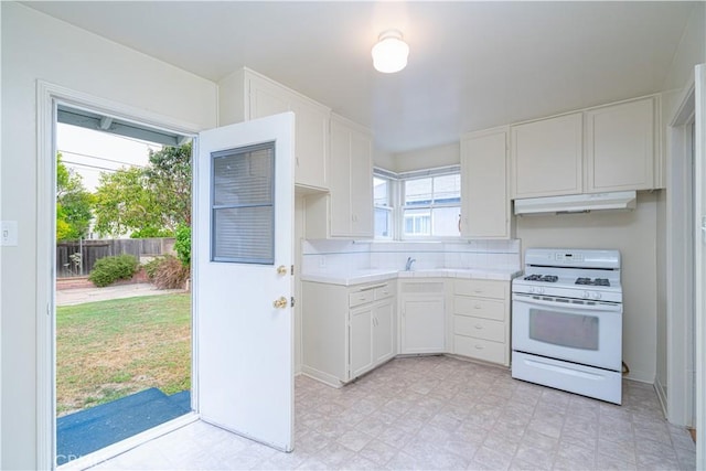 2124 Rutgers Ave, Long Beach, CA 90815 - kitchen featuring white range with gas cooktop, under cabinet range hood, white cabinetry, and light flooring