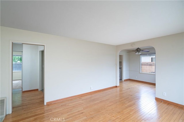 2124 Rutgers Ave, Long Beach, CA 90815 - unfurnished room featuring arched walkways, healthy amount of natural light, light wood-type flooring, and a ceiling fan
