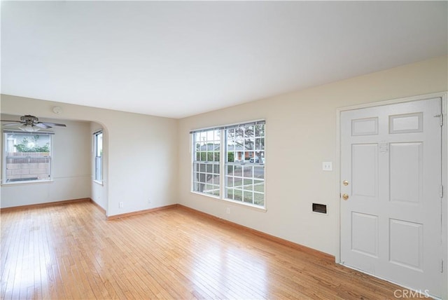 2124 Rutgers Ave, Long Beach, CA 90815 - unfurnished living room featuring light wood finished floors, a ceiling fan, and arched walkways