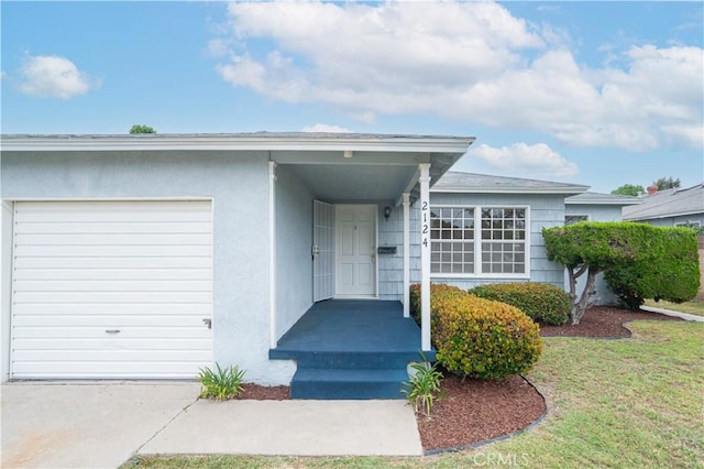 2124 Rutgers Ave, Long Beach, CA 90815 - entrance to property with an attached garage, a lawn, and stucco siding