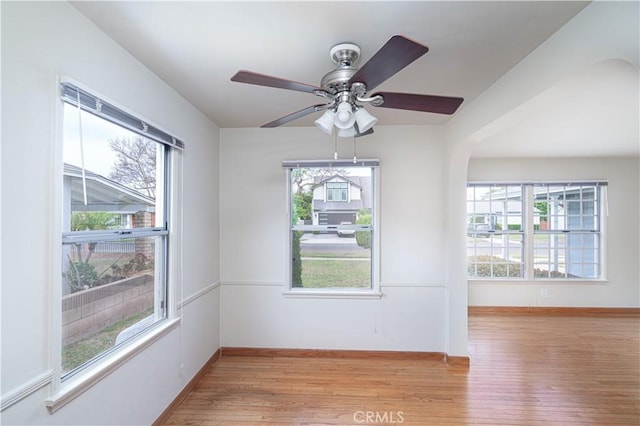2124 Rutgers Ave, Long Beach, CA 90815 - empty room featuring healthy amount of natural light, light wood finished floors, and arched walkways