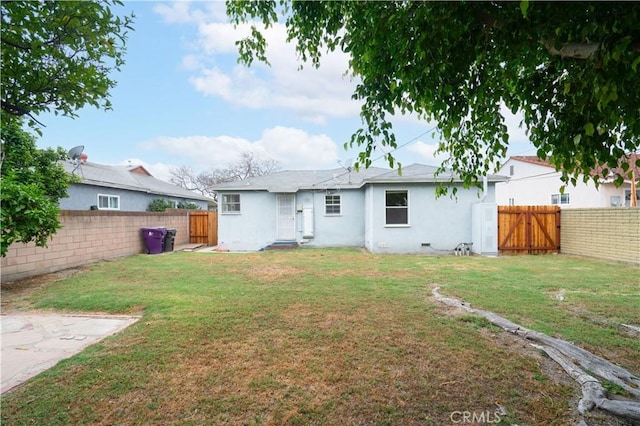 2124 Rutgers Ave, Long Beach, CA 90815 - back of house with a fenced backyard, stucco siding, and a gate