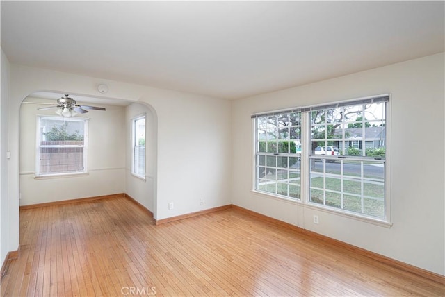 2124 Rutgers Ave, Long Beach, CA 90815 - spare room featuring light wood finished floors, a ceiling fan, arched walkways, and a smoke detector
