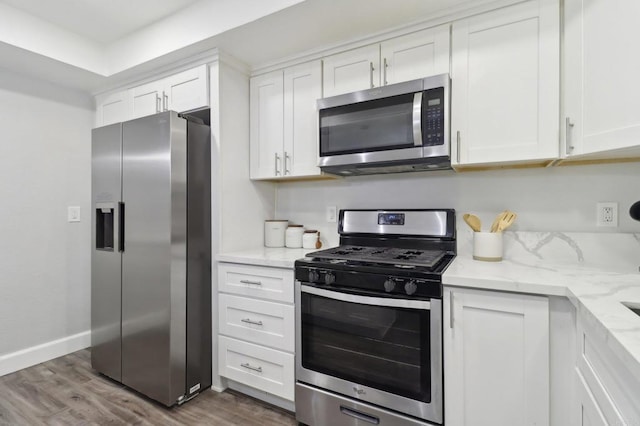 1204 E El Norte Pkwy, Escondido, CA 92027 - kitchen featuring appliances with stainless steel finishes, dark wood-style flooring, white cabinetry, and light stone countertops