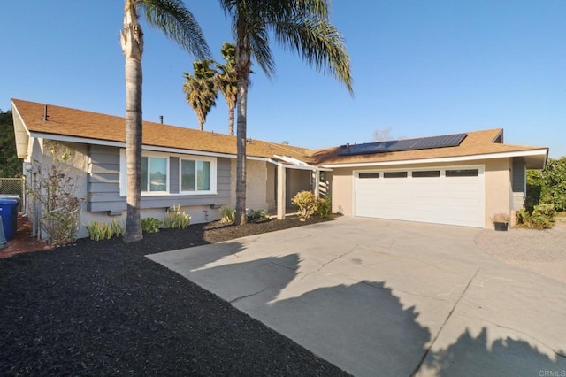 1204 E El Norte Pkwy, Escondido, CA 92027 - ranch-style home with roof mounted solar panels, driveway, a garage, and stucco siding