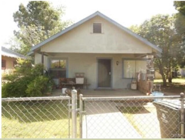 32493255 Myers St, Oroville, CA 95966 - bungalow-style home featuring a gate, stucco siding, and a porch