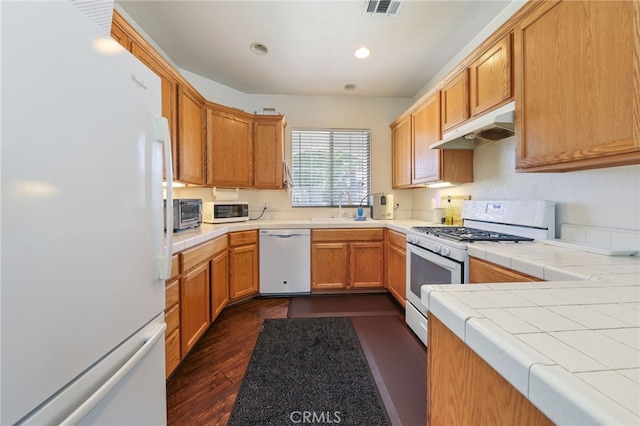 251 E Center St, Covina, CA 91723 - kitchen featuring white appliances, under cabinet range hood, tile countertops, dark wood finished floors, and recessed lighting