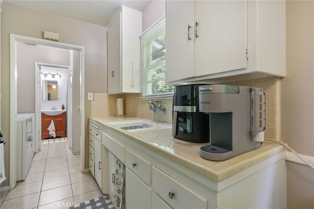 251 E Center St, Covina, CA 91723 - kitchen with tile countertops, white cabinets, light tile patterned floors, and decorative backsplash