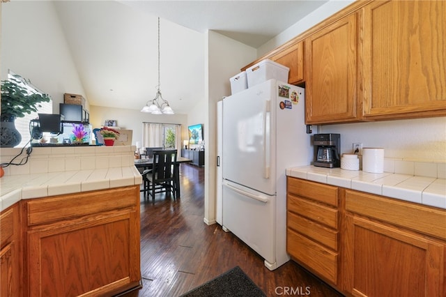 251 E Center St, Covina, CA 91723 - kitchen featuring freestanding refrigerator, a chandelier, dark wood-style floors, lofted ceiling, and brown cabinetry