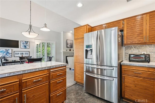 26107 Mcbean Unit 62, Valencia, CA 91355 - kitchen with stainless steel fridge with ice dispenser, brown cabinets, light countertops, backsplash, and recessed lighting