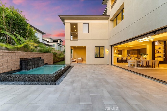 61 Dorado, Irvine, CA 92618 - back of house with a jacuzzi, a patio area, and stucco siding