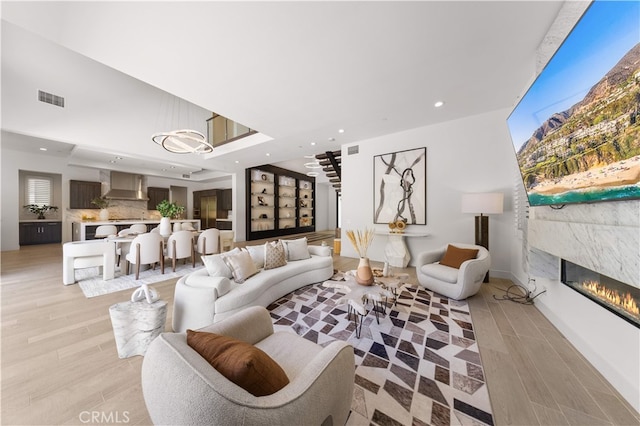 61 Dorado, Irvine, CA 92618 - living room featuring a glass covered fireplace, recessed lighting, and light wood-style flooring