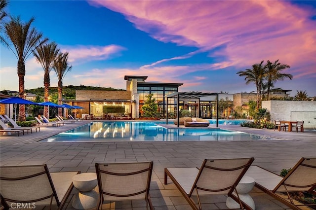 61 Dorado, Irvine, CA 92618 - pool at dusk with a patio area, a community pool, and a pergola