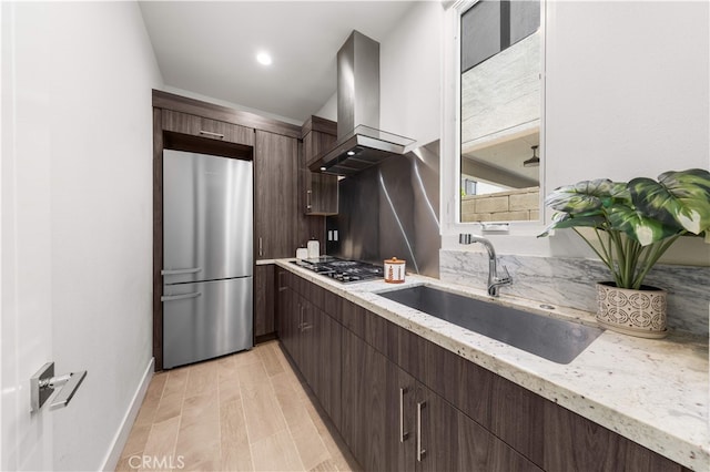 61 Dorado, Irvine, CA 92618 - kitchen featuring appliances with stainless steel finishes, island range hood, dark brown cabinets, and light stone counters