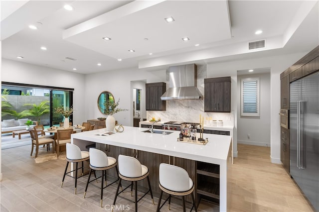 61 Dorado, Irvine, CA 92618 - kitchen featuring wall chimney range hood, built in refrigerator, modern cabinets, decorative backsplash, and recessed lighting