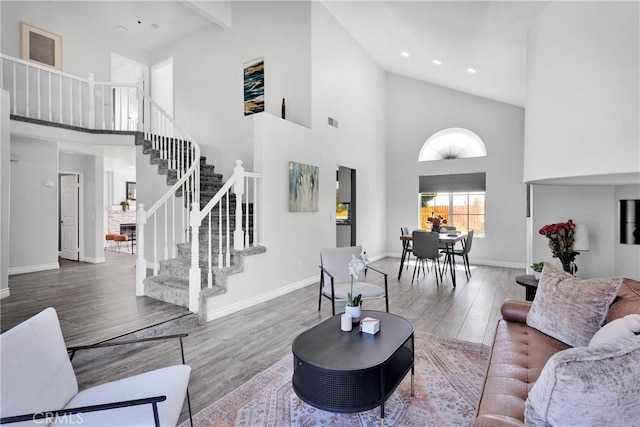 12725 Sundown Rd, Victorville, CA 92392 - living area featuring high vaulted ceiling, stairs, wood finished floors, and recessed lighting