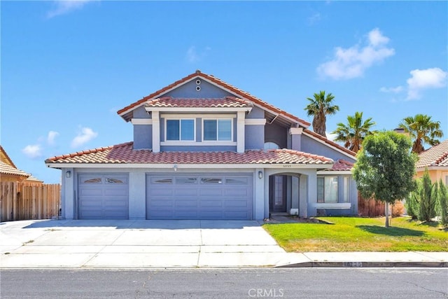 12725 Sundown Rd, Victorville, CA 92392 - mediterranean / spanish house featuring a tile roof, stucco siding, driveway, and an attached garage