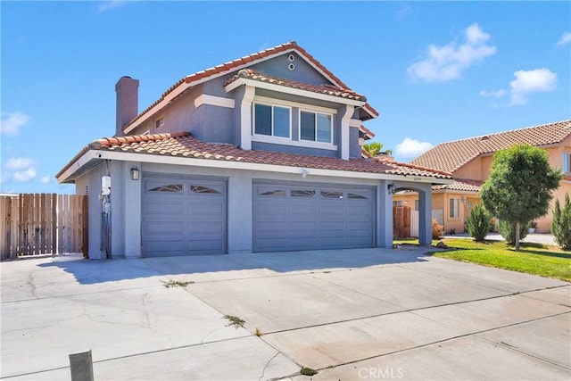 12725 Sundown Rd, Victorville, CA 92392 - mediterranean / spanish-style home featuring driveway, stucco siding, a garage, a tile roof, and a chimney
