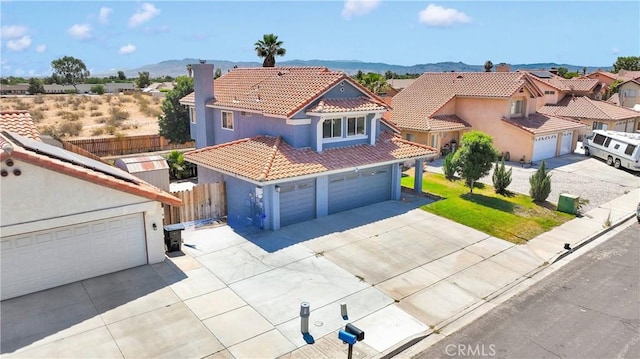 12725 Sundown Rd, Victorville, CA 92392 - mediterranean / spanish house with a tiled roof, stucco siding, driveway, and a mountain view