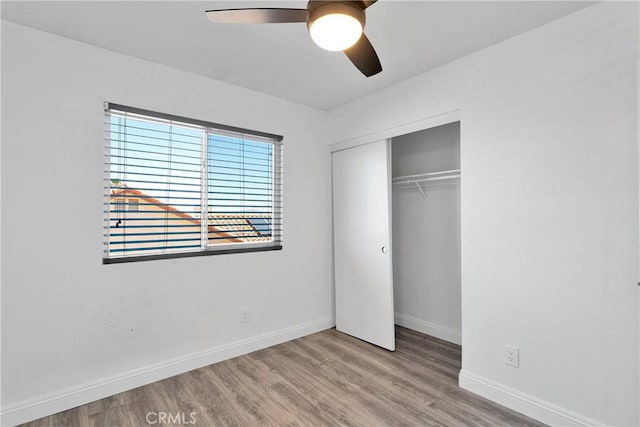 12725 Sundown Rd, Victorville, CA 92392 - unfurnished bedroom featuring a closet, wood finished floors, and ceiling fan