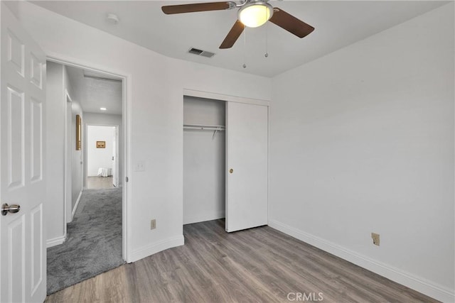 12725 Sundown Rd, Victorville, CA 92392 - unfurnished bedroom with wood finished floors, a closet, and ceiling fan