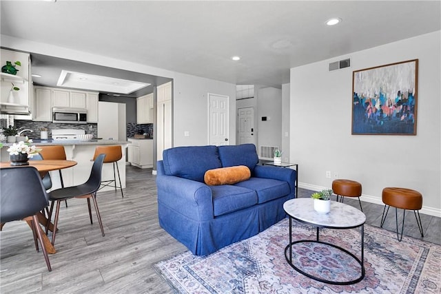 12725 Sundown Rd, Victorville, CA 92392 - living room with light wood-style flooring and recessed lighting