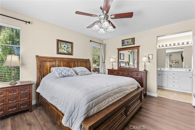 39903 Millbrook Way Unit 7C, Murrieta, CA 92563 - bedroom with wood finished floors, multiple windows, ensuite bath, and a ceiling fan