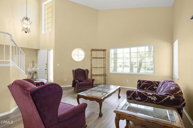 2085 Koala Pl, Oxnard, CA 93036 - living room featuring a high ceiling, stairs, wood finished floors, and a chandelier