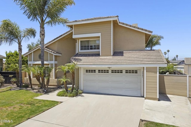 2085 Koala Pl, Oxnard, CA 93036 - view of front of property featuring driveway, an attached garage, a tile roof, and stucco siding