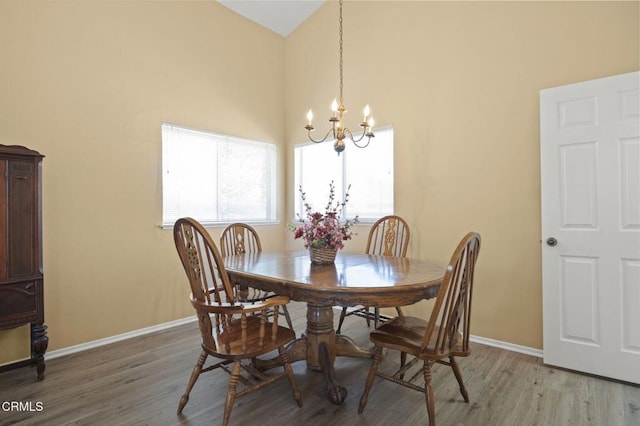 2085 Koala Pl, Oxnard, CA 93036 - dining space with a chandelier, light wood-style floors, and a high ceiling