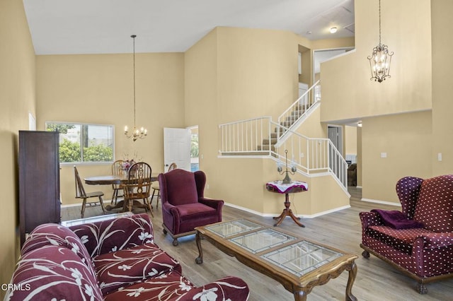 2085 Koala Pl, Oxnard, CA 93036 - living area with a chandelier, wood finished floors, stairs, and a towering ceiling