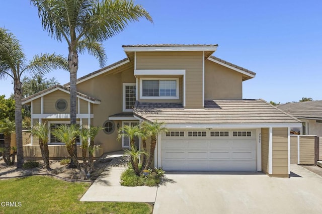 2085 Koala Pl, Oxnard, CA 93036 - traditional-style house featuring driveway, stucco siding, an attached garage, and a tiled roof