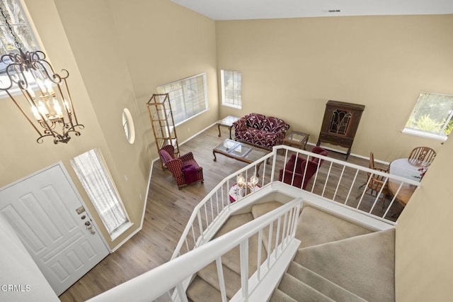 2085 Koala Pl, Oxnard, CA 93036 - stairs with wood finished floors, a towering ceiling, and a chandelier