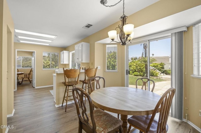 2085 Koala Pl, Oxnard, CA 93036 - dining space with light wood finished floors and a chandelier