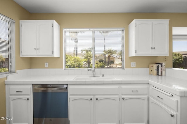 2085 Koala Pl, Oxnard, CA 93036 - kitchen featuring dishwashing machine, white cabinets, and tile counters