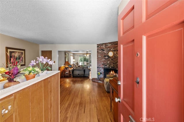21041 Lanark St, Canoga Park, CA 91304 - foyer entrance with a textured ceiling, wood finished floors, and a brick fireplace