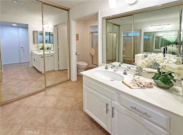 3525 Bahia Blanca W Unit B, Laguna Woods, CA 92637 - full bath featuring a textured ceiling, vanity, tile patterned flooring, and a stall shower