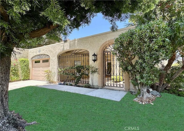 3525 Bahia Blanca W Unit B, Laguna Woods, CA 92637 - view of front of house with stucco siding, driveway, a front yard, and a garage