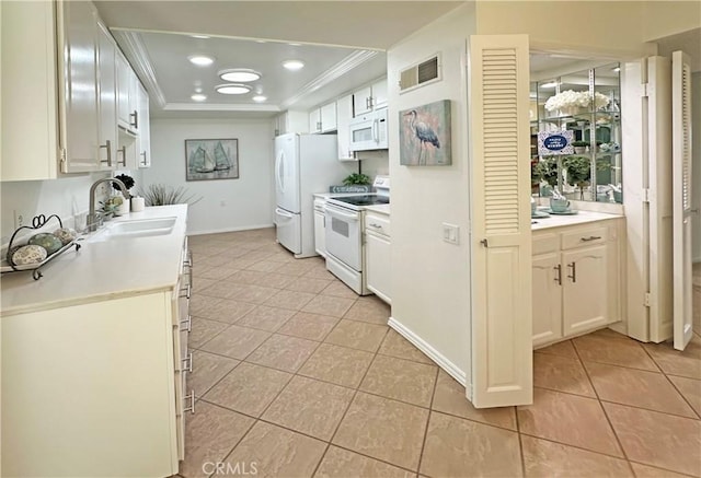 3525 Bahia Blanca W Unit B, Laguna Woods, CA 92637 - kitchen with white appliances, ornamental molding, light tile patterned floors, a raised ceiling, and light countertops
