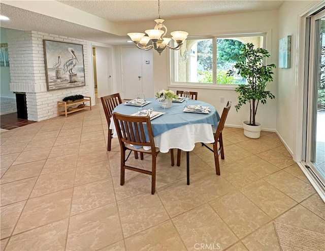 3525 Bahia Blanca W Unit B, Laguna Woods, CA 92637 - dining room with a textured ceiling, light tile patterned floors, a chandelier, and a fireplace