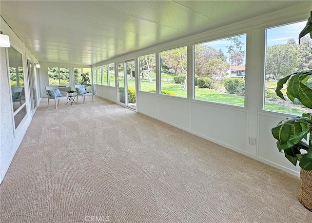 3525 Bahia Blanca W Unit B, Laguna Woods, CA 92637 - unfurnished sunroom featuring plenty of natural light and carpet floors