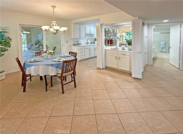 3525 Bahia Blanca W Unit B, Laguna Woods, CA 92637 - dining area featuring a chandelier, a textured ceiling, and light tile patterned floors