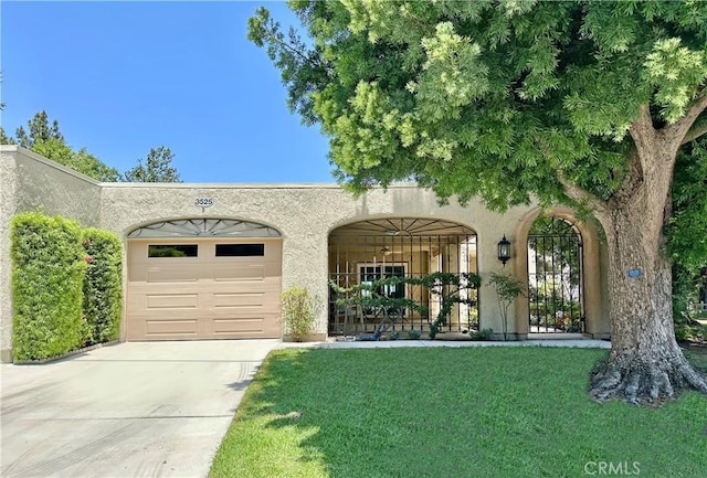 3525 Bahia Blanca W Unit B, Laguna Woods, CA 92637 - mediterranean / spanish-style house with an attached garage, driveway, stucco siding, and a front lawn