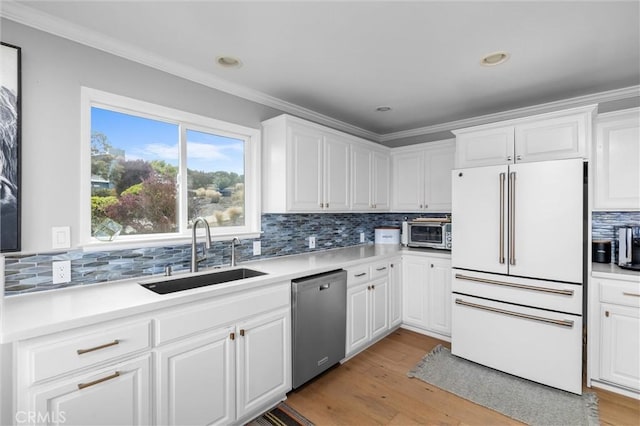 329 Travis Dr, Los Osos, CA 93402 - kitchen with freestanding refrigerator, stainless steel dishwasher, ornamental molding, tasteful backsplash, and white cabinets