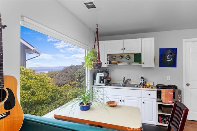329 Travis Dr, Los Osos, CA 93402 - kitchen with open shelves, white cabinets, and light countertops