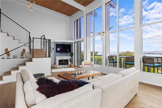 329 Travis Dr, Los Osos, CA 93402 - living area featuring stairway, a wooden ceiling with exposed beams, wood finished floors, high vaulted ceiling, and a fireplace