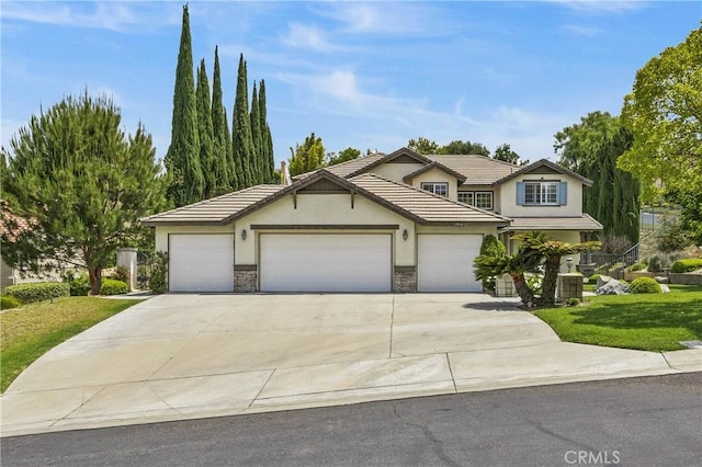 2504 Martingail Dr, Covina, CA 91724 - traditional home featuring stucco siding, driveway, stone siding, a garage, and a front lawn