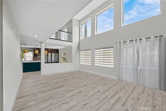2504 Martingail Dr, Covina, CA 91724 - unfurnished living room featuring wood finished floors, a high ceiling, and recessed lighting